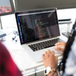 Person working on SEO strategy using a laptop, guided by a website design agency in Singapore