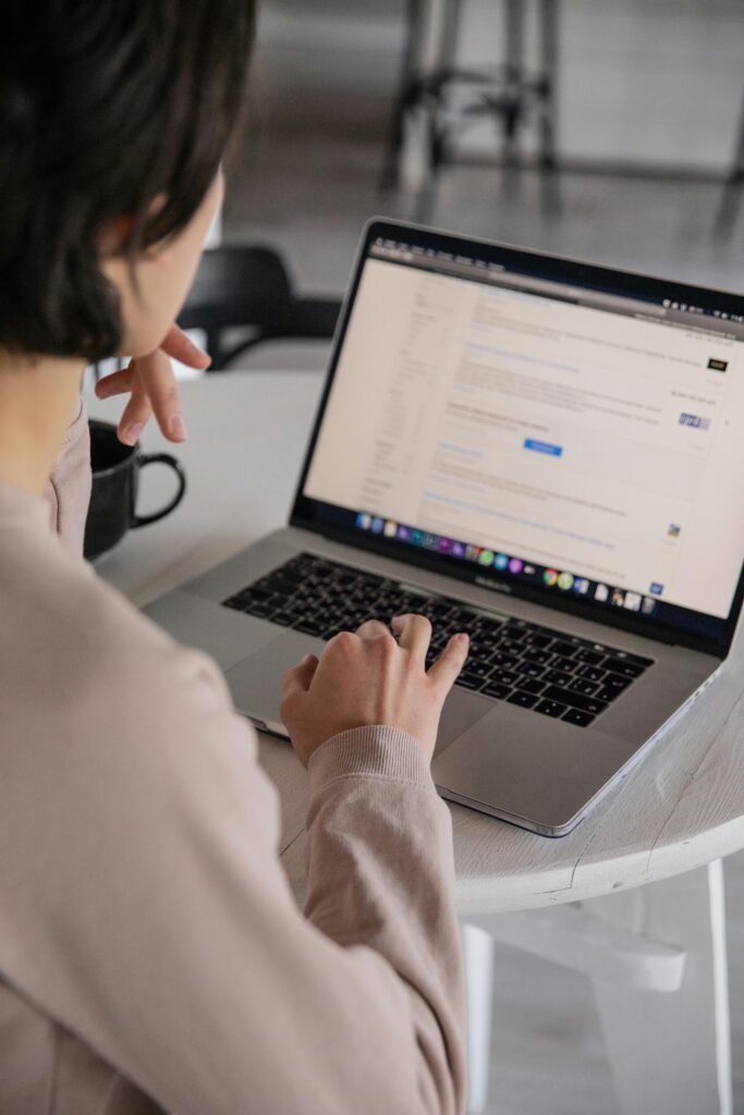 Businesswoman typing keywords into her website with help from a website design agency in Singapore