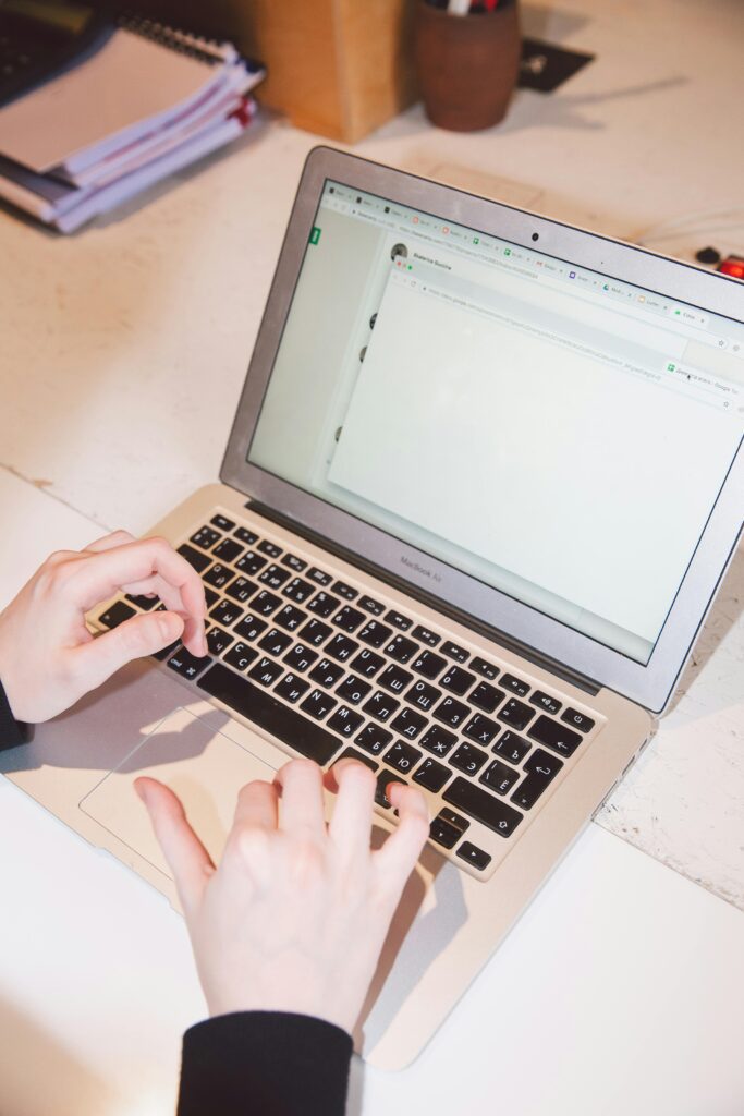 Laptop and papers showing how a web designing agency builds high-converting campaigns