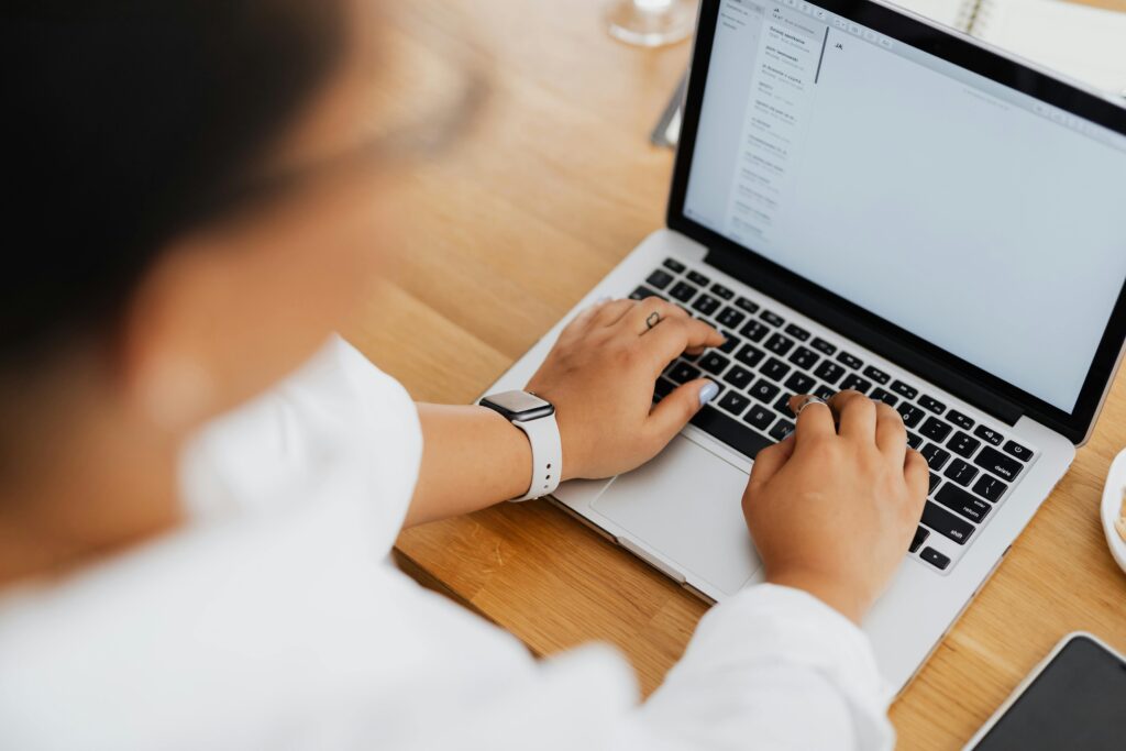 Laptop and papers showing how a web designing agency builds high-converting campaigns
