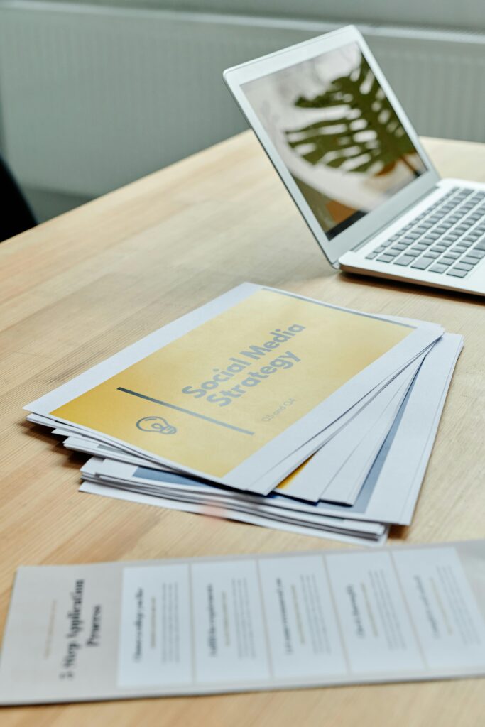 Laptop and papers showing how a web designing agency builds high-converting campaigns