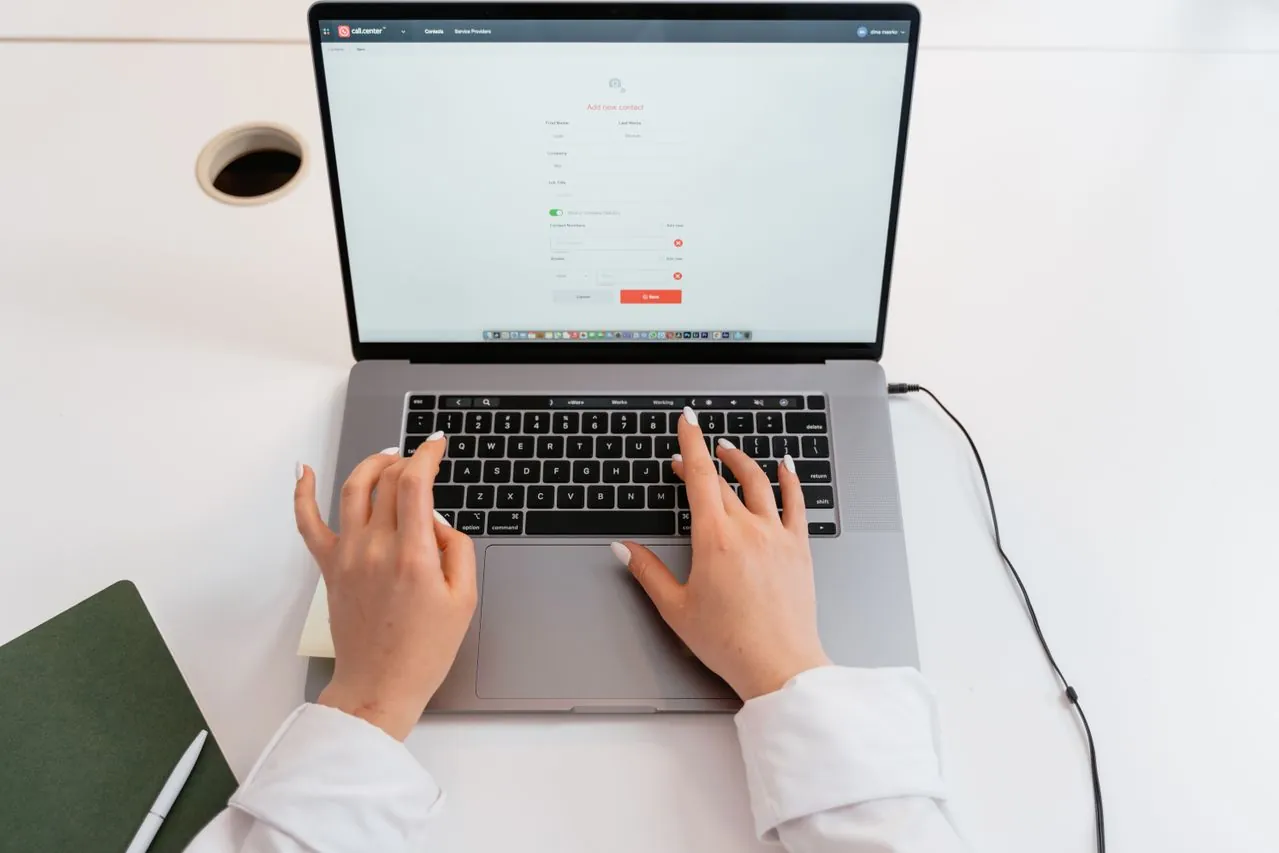 User interacting with a website on a laptop, focusing on interface elements and call-to-action options.