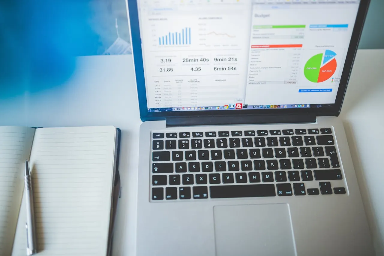 Open laptop displaying digital marketing agency analytics graphs and charts. 