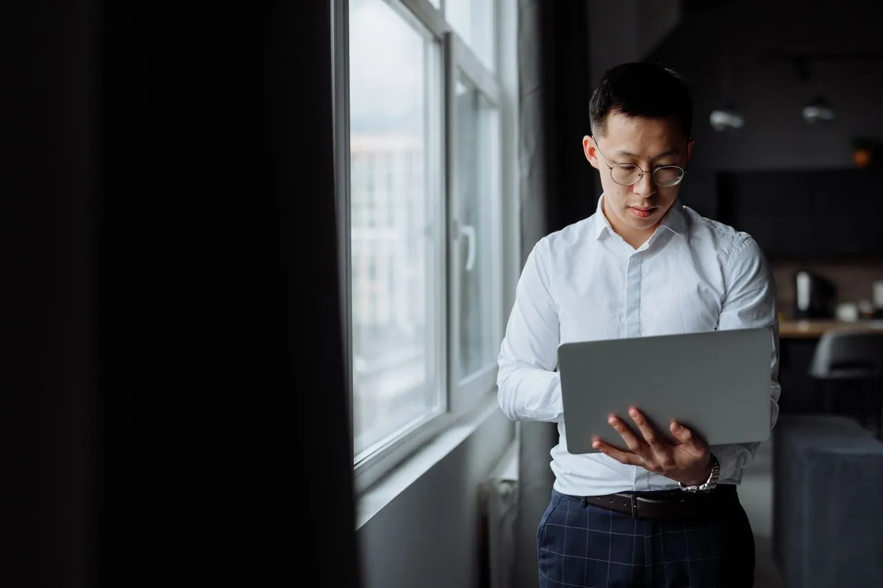 Business professional managing a company website to support web security, reliability, and customer trust.