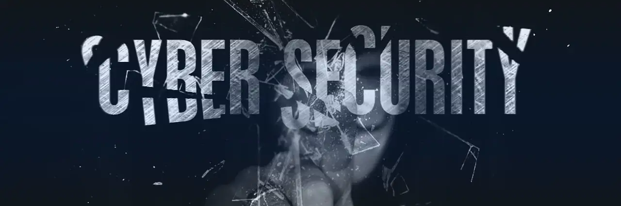 A concept image with the word cybersecurity being shattered by a hacker.