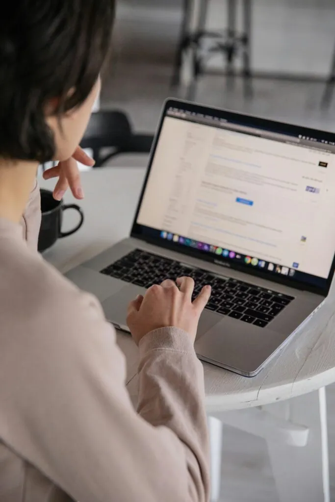 Businesswoman typing keywords into her website with help from a website design agency in Singapore